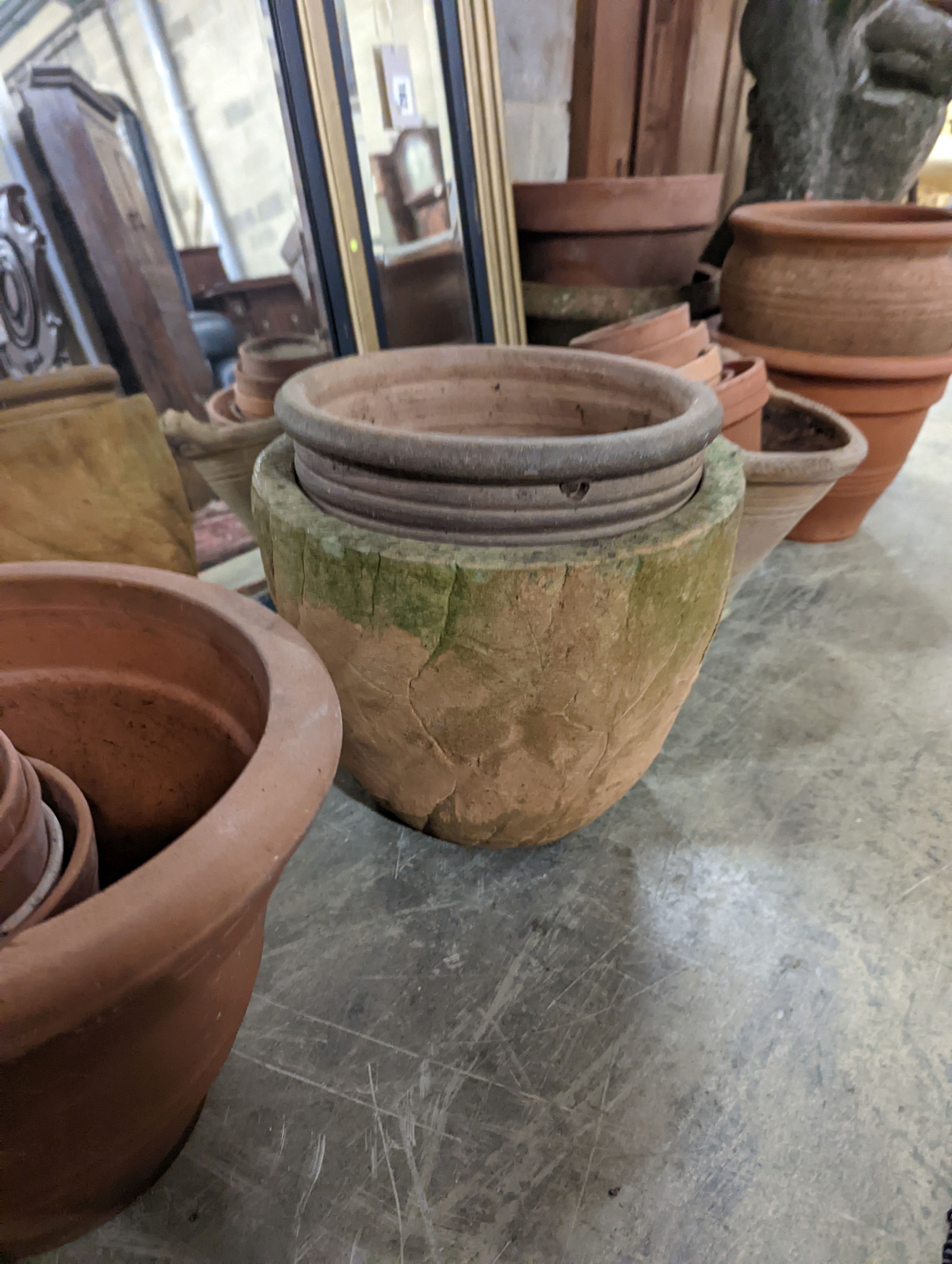 A collection of approximately 20 assorted terracotta garden planters, largest diameter 35cm